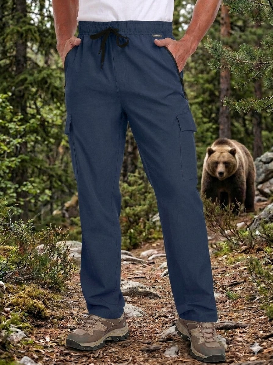 Person wearing blue cargo pants standing on a forest path with a bear in the background iggreenbear.com