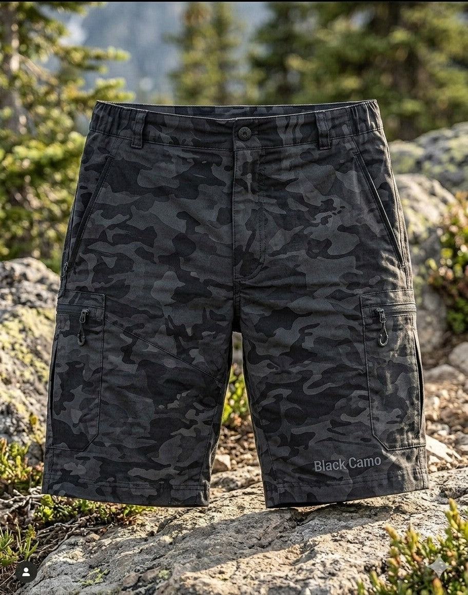 Front view of Big Green Bear Men's Black Camo Hiking Cargo Shorts on a hiker in a mountain setting with a bear in the background.