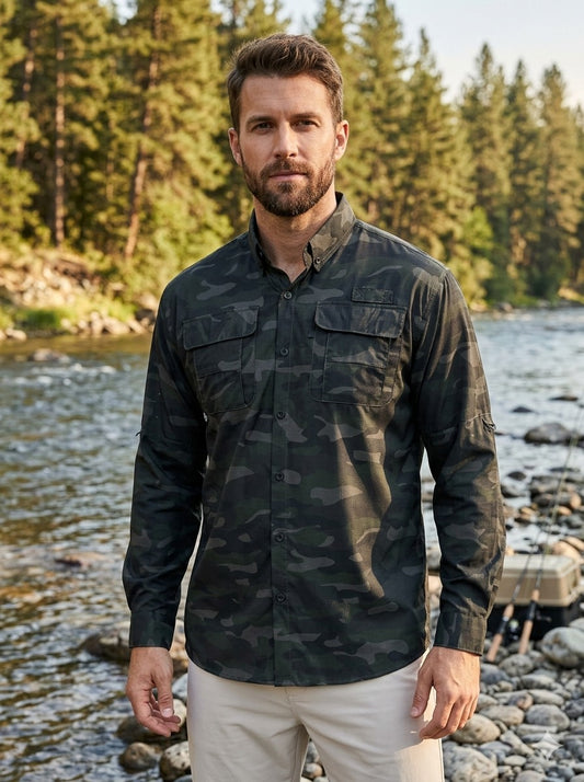 Man wearing a camouflage shirt standing by a river with trees in the background Big Green Bear