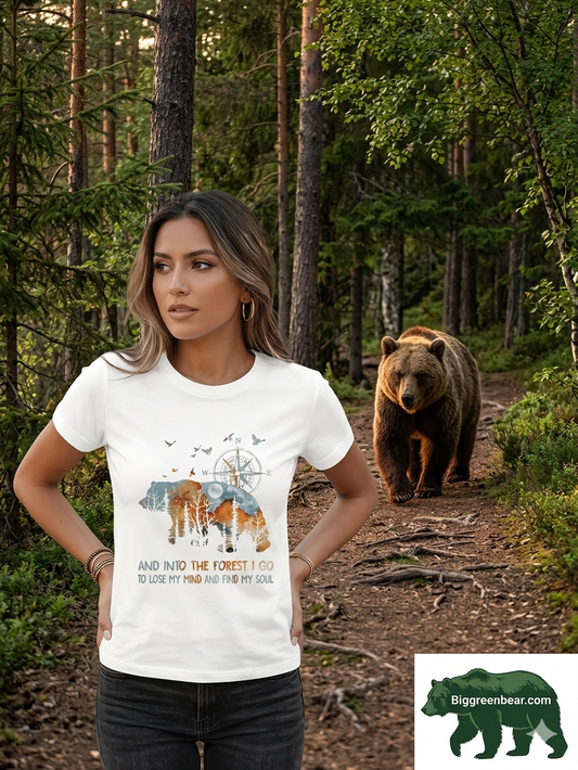 Woman wearing a t-shirt with a bear graphic and text in a forest setting Biggreenbear.com Big Green Bear